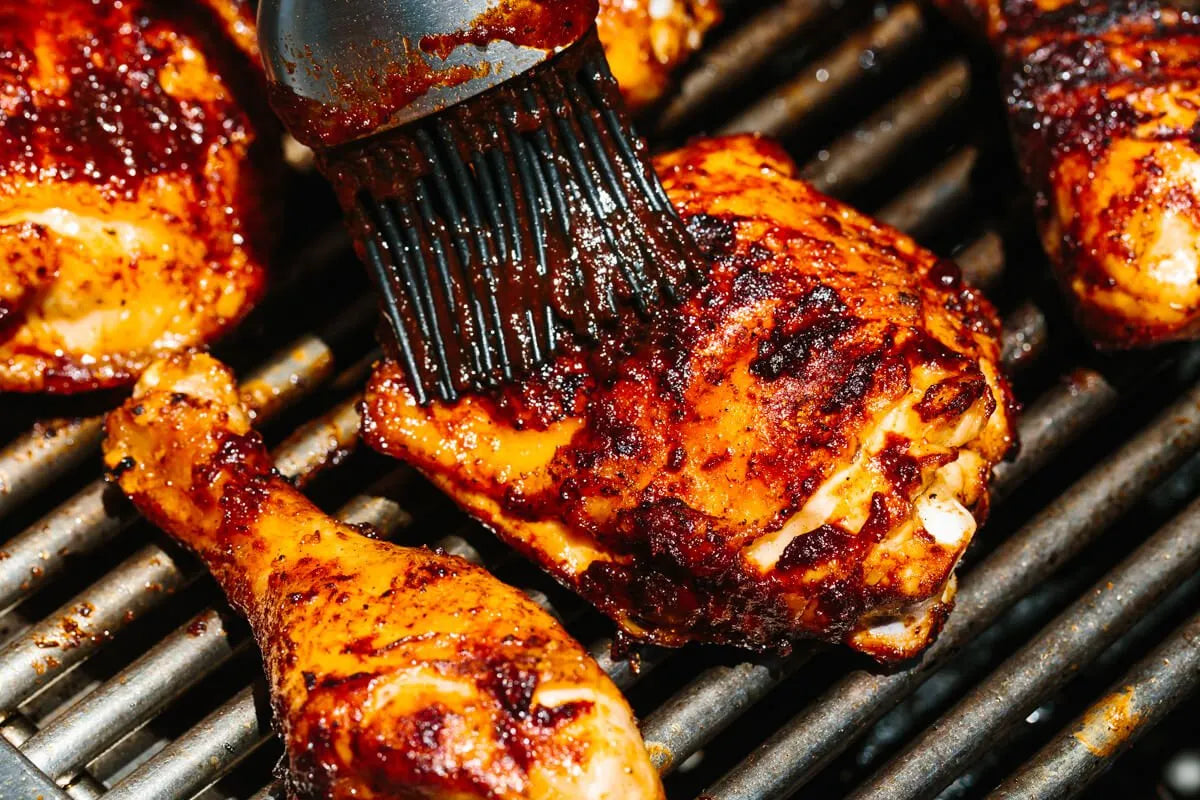 3 people sitting around the table and cutting a BBQ chicken